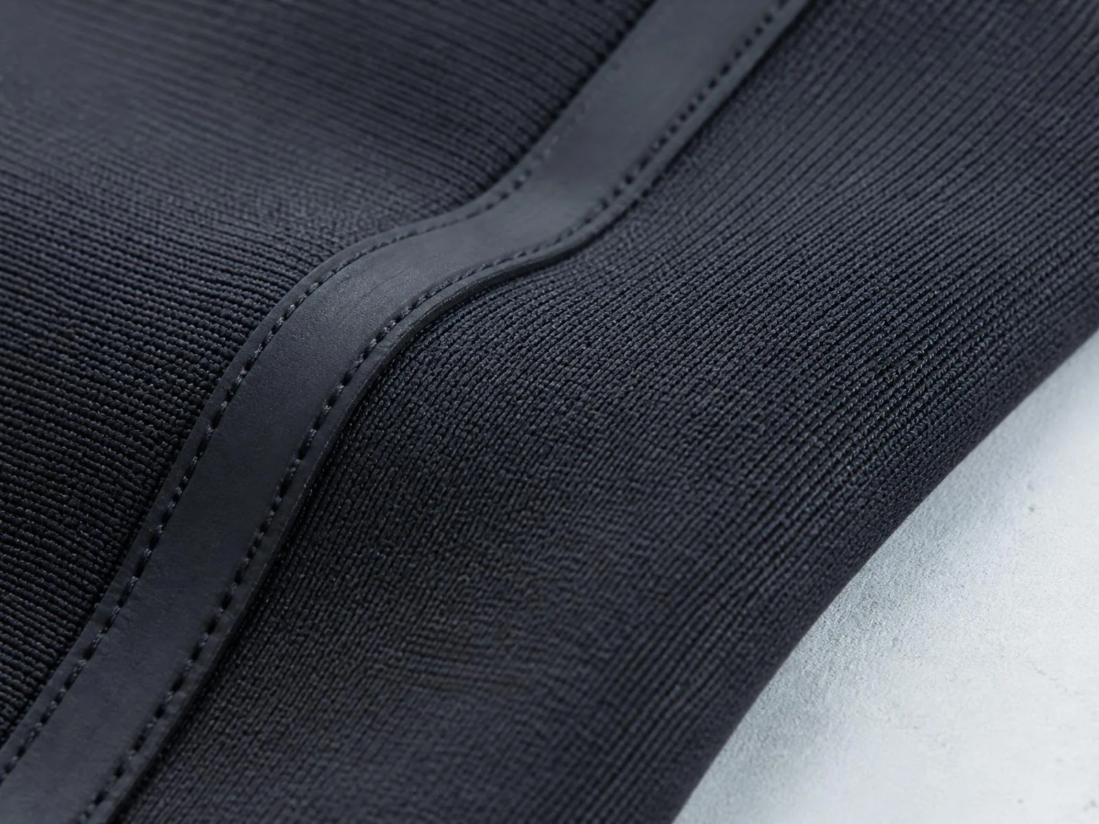 Macro study of matte technical knit and bonded seam